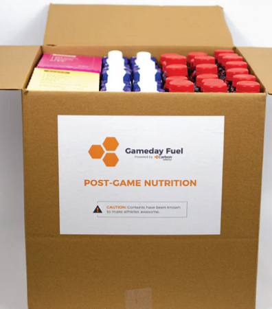 Box of Gameday Fuel post-game nutrition products with a visible label.