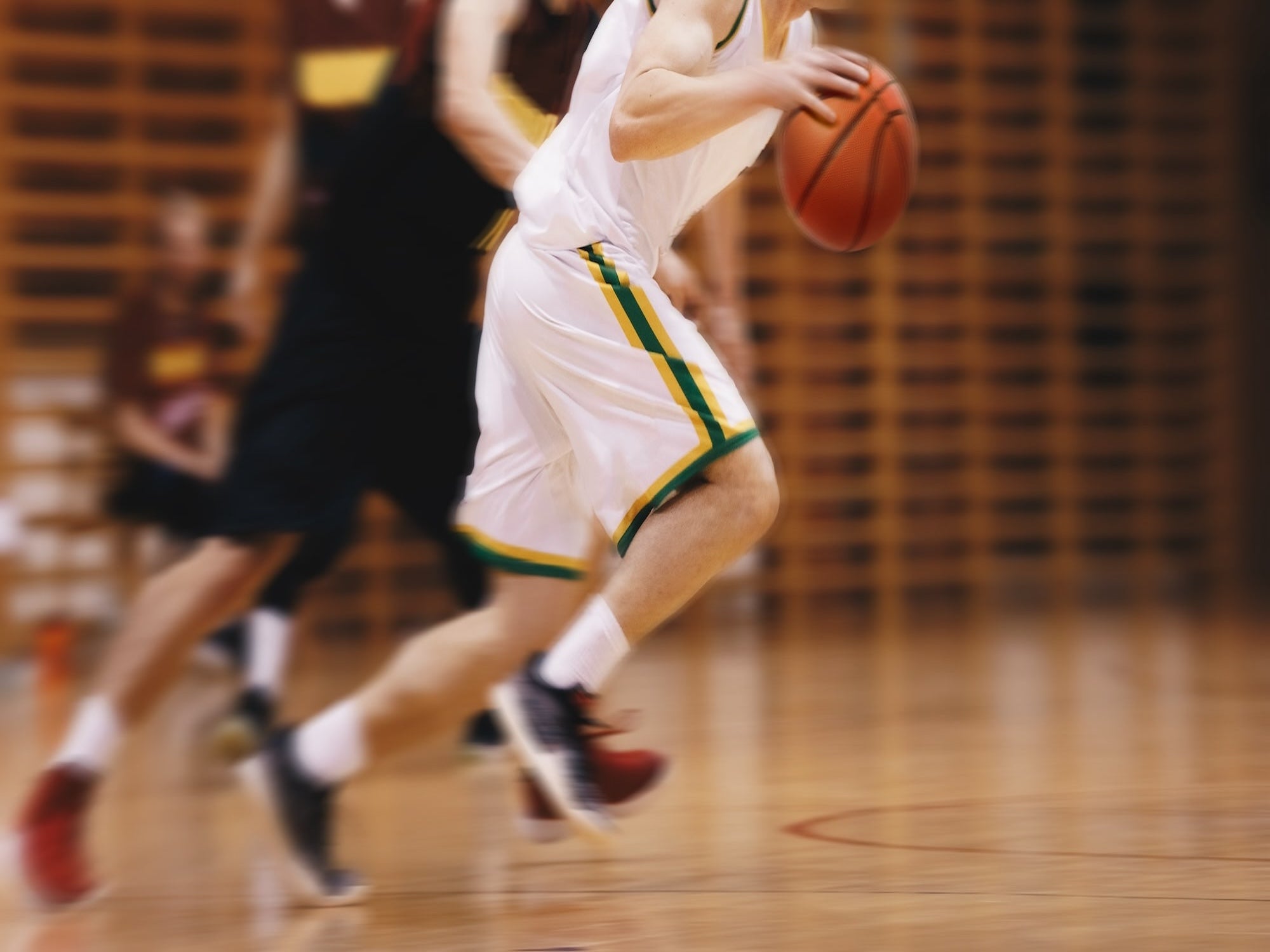 Basketball player in action on a court with a blurred background