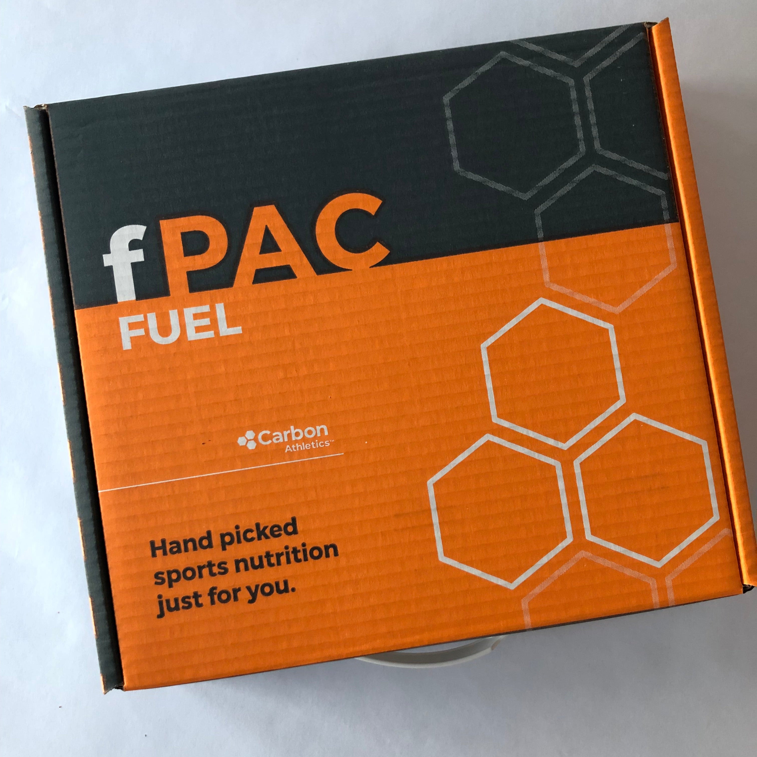 fPAC Fuel box with orange and black design on a light gray background